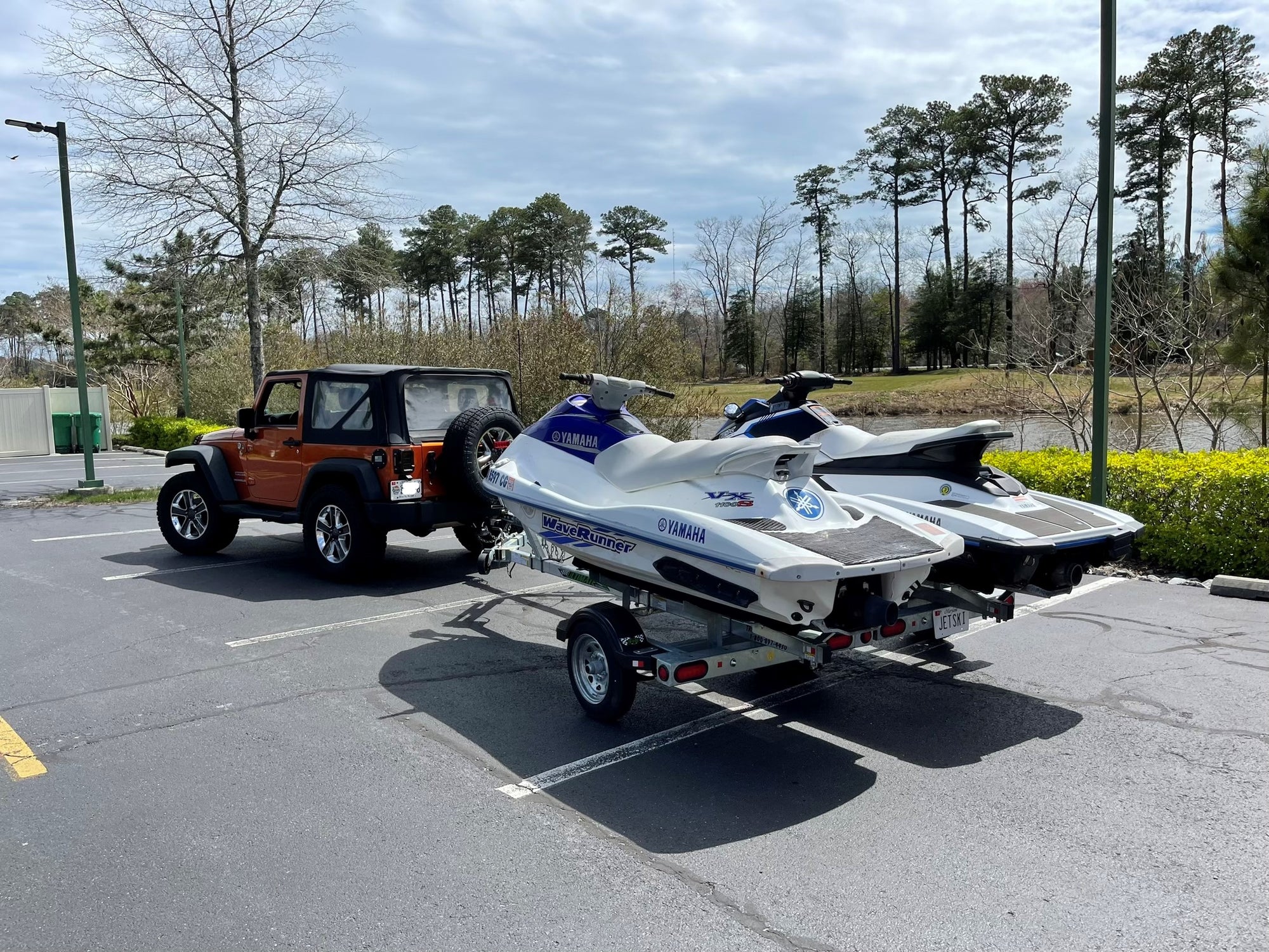 jeep pulling two jet skis on 2n1 trailer